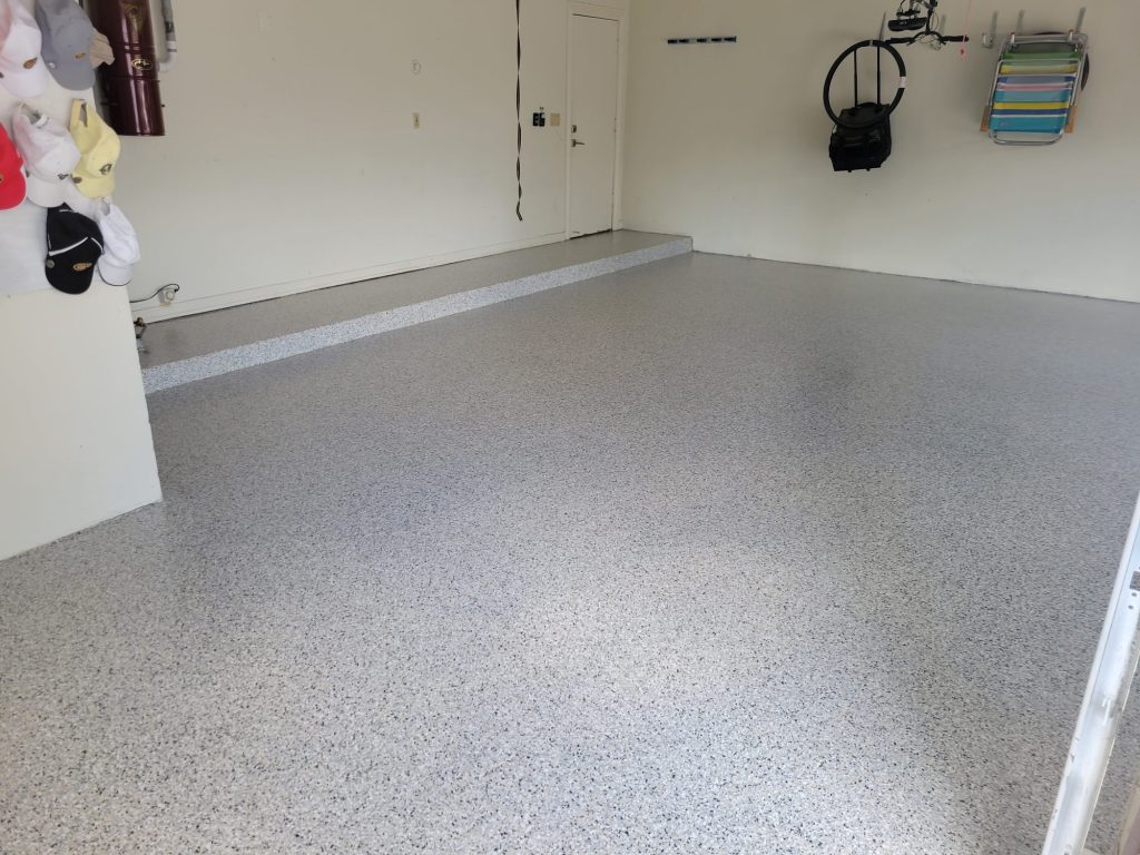 jc-elite-epoxy-flooring-co-owner-jose-rossman Polyaspartic flooring: wide view of a finished gray flake epoxy garage floor