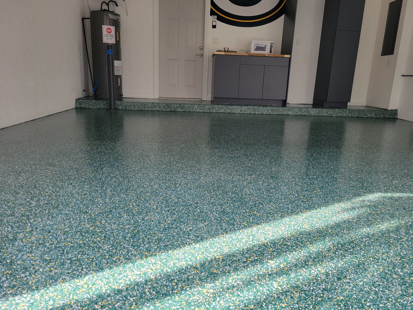 Finished green and gold flake epoxy garage floor