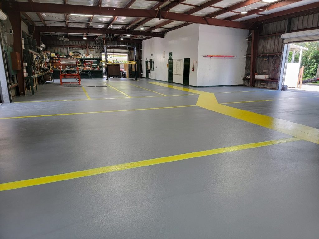 jc-elite-epoxy-flooring-co-owner-jose-rossman Commercial epoxy flooring Fort Lauderdale: gray industrial shop epoxy floor with yellow safety lines