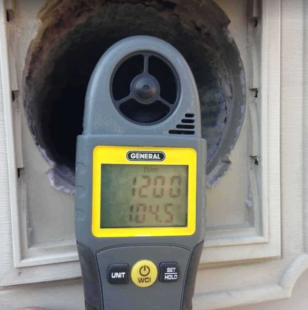 JCS Home Services airflow meter verifying a freshly cleaned dryer vent in Arlington VA