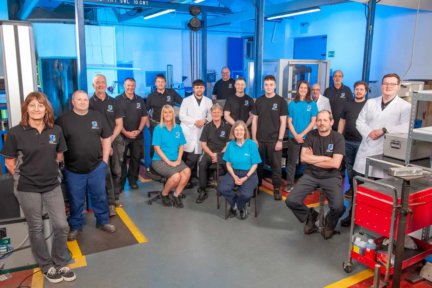 Group photo of Keighley Laboratories staff in a high-tech lab environment.