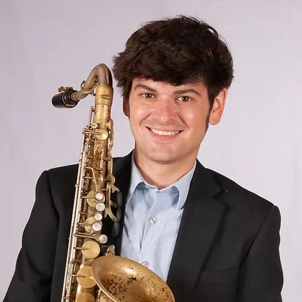 Austin Cebulske, saxophone instructor at iGnitE jAzz! 2026, holding a tenor saxophone.