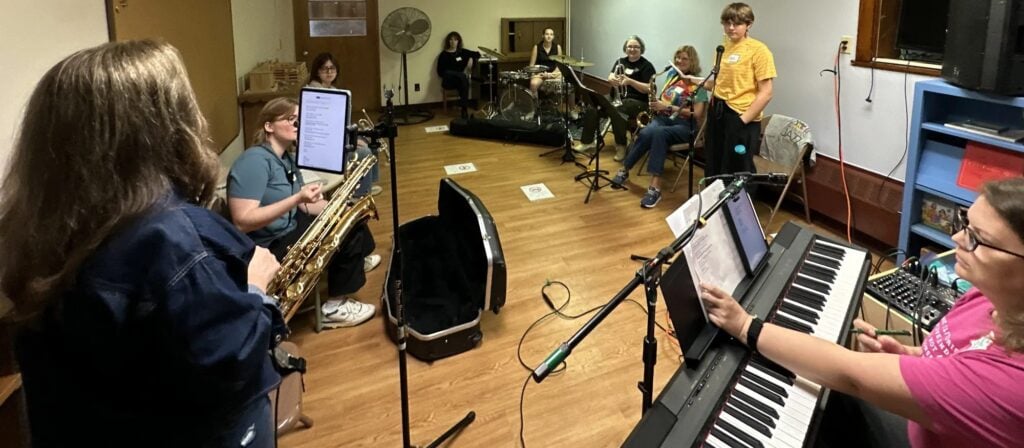 A saxophonist and keyboard player rehearse together in a side room at iGnitE jAzz! 2026