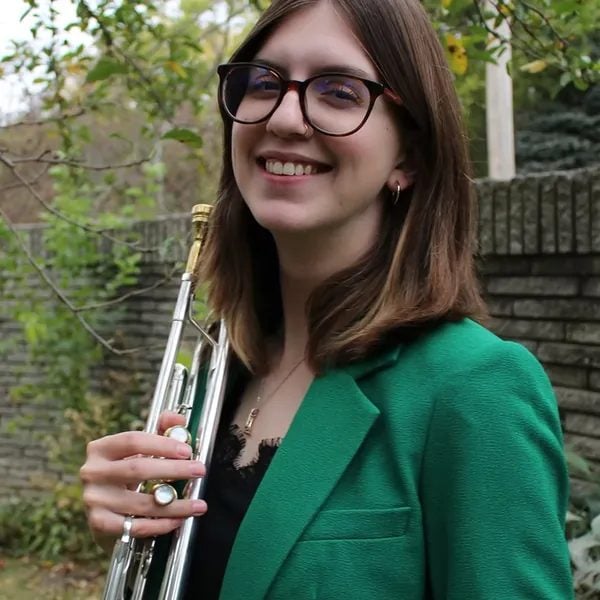 Katherine Schmit, trumpet instructor at iGnitE jAzz! 2026, holding a trumpet.