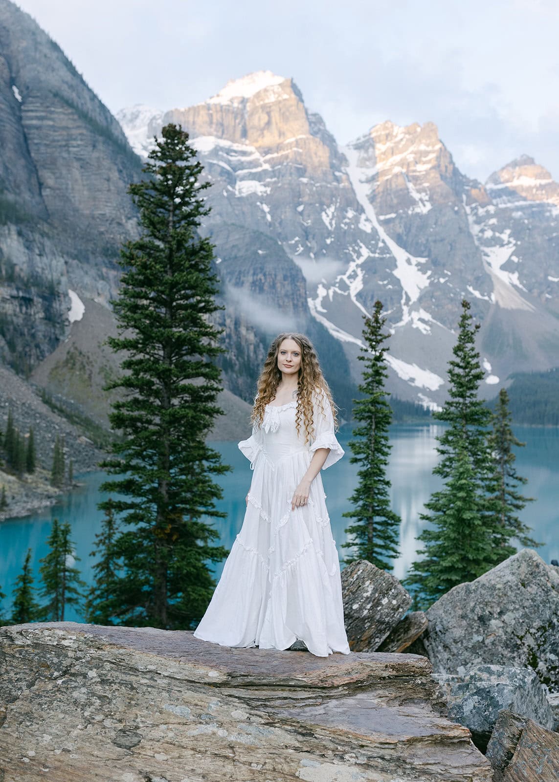 Romantic Alberta elopement with mountain views and alpine lake backdrop