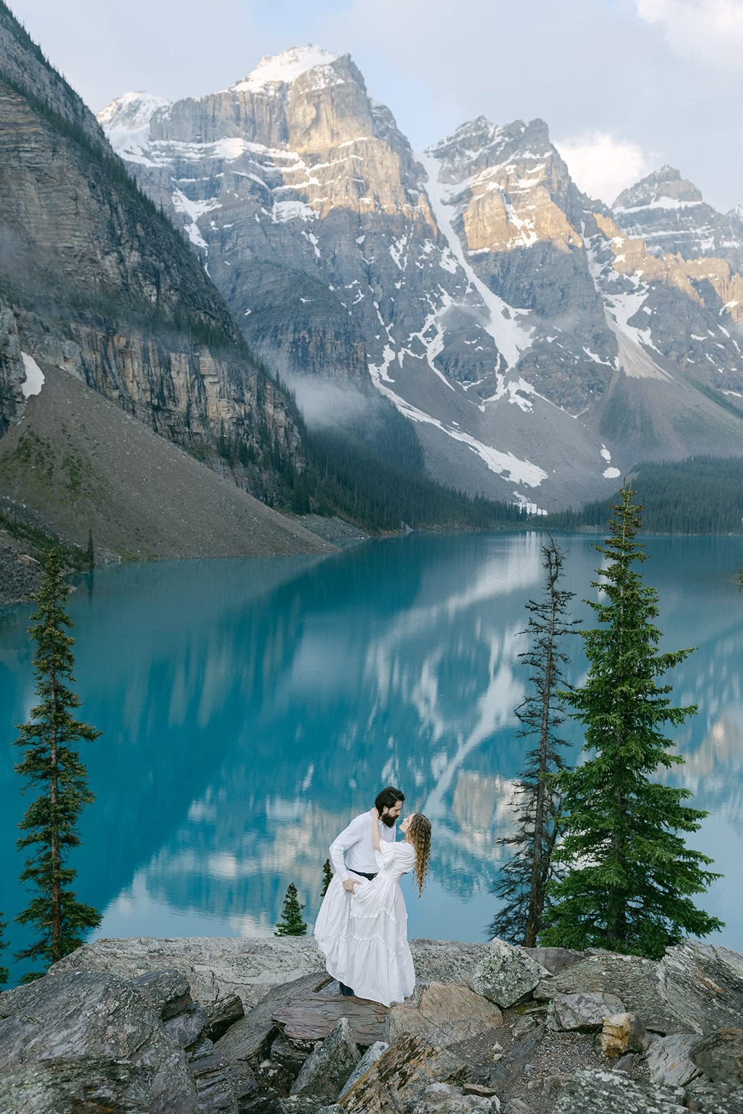 Banff elopement photographer capturing a couple beside a turquoise lake in the Canadian Rockies