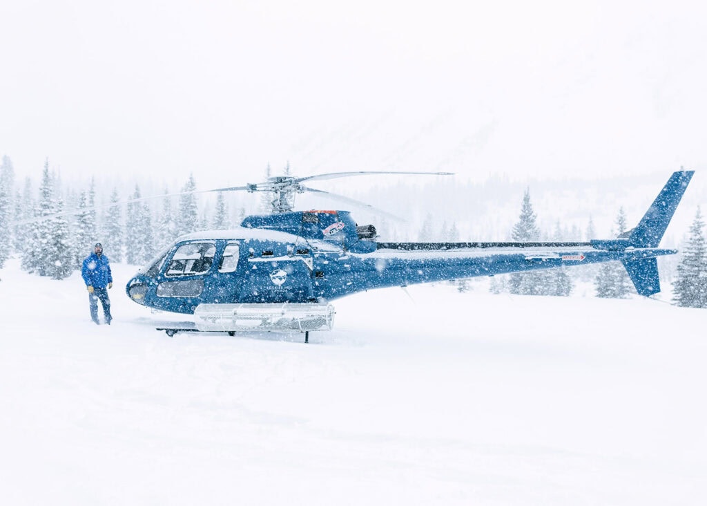 Helicopter landing on remote mountain peak in Golden BC for elopement ceremony
