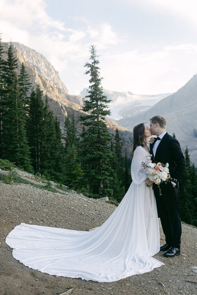 Golden elopement couple standing in dramatic mountain landscape