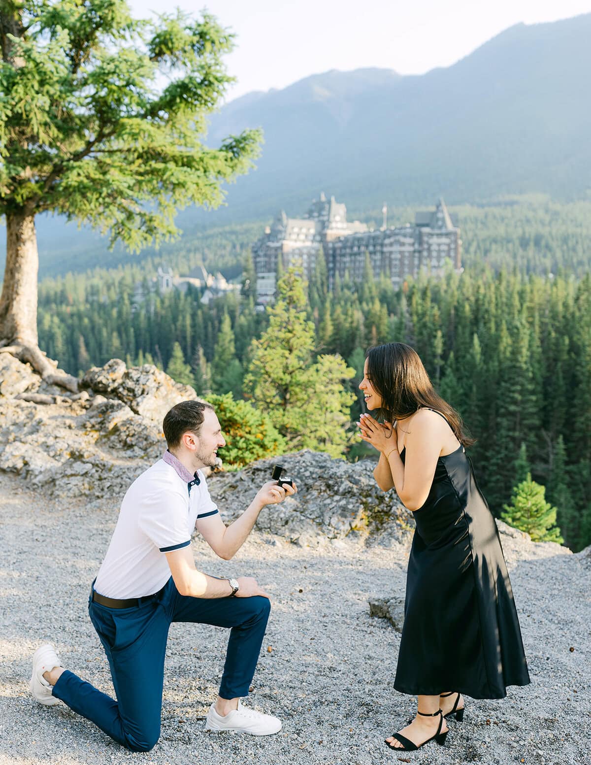 Romantic Surprise Corner engagement with iconic Fairmont Banff view at sunset in the Canadian Rockies