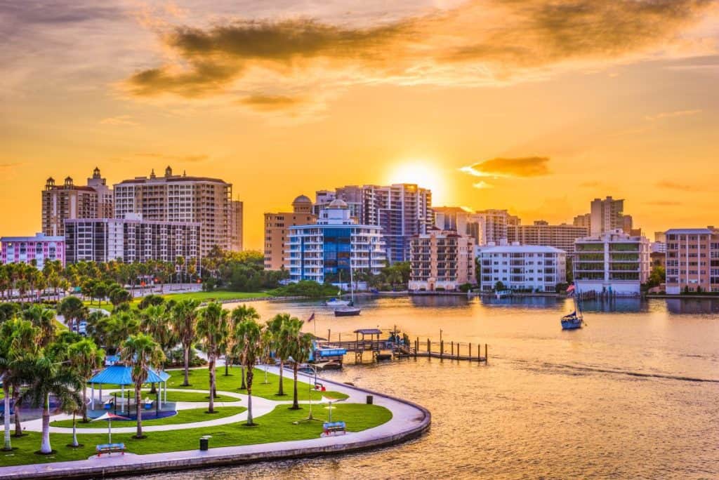 Waterfront condominiums and high-rise buildings in Florida at sunset, representing real estate protection needing to be covered by property and casualty insurance.