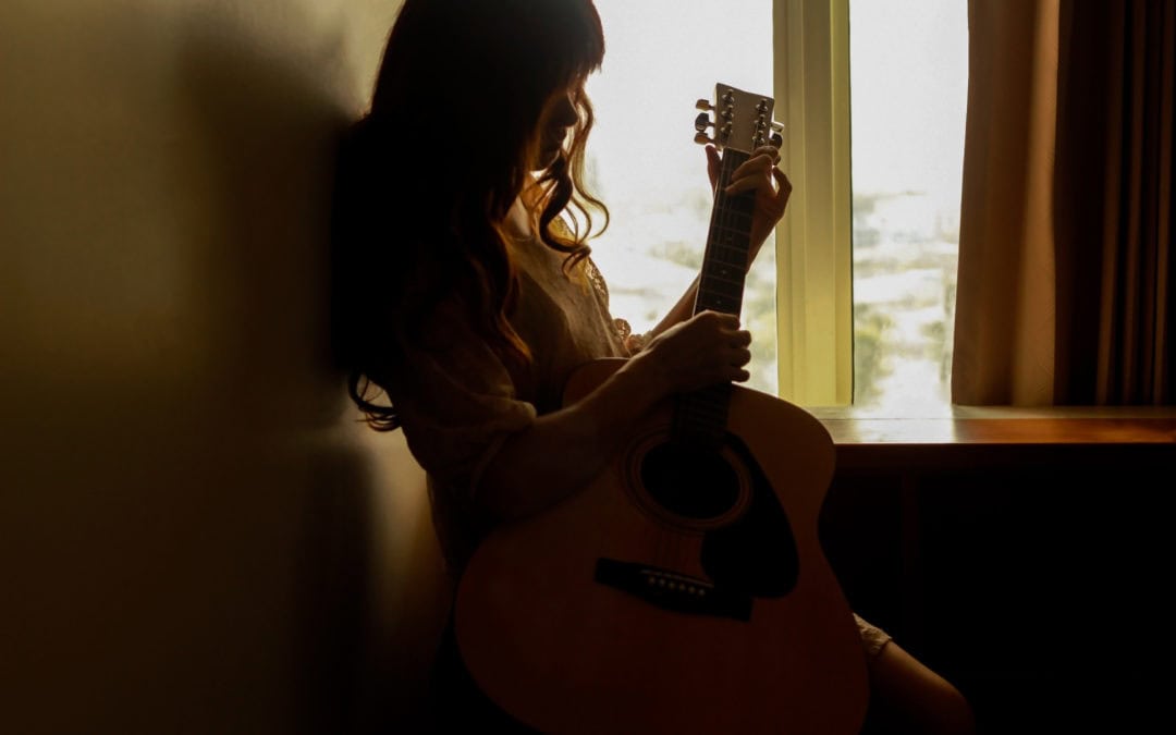 young woman playing guitar