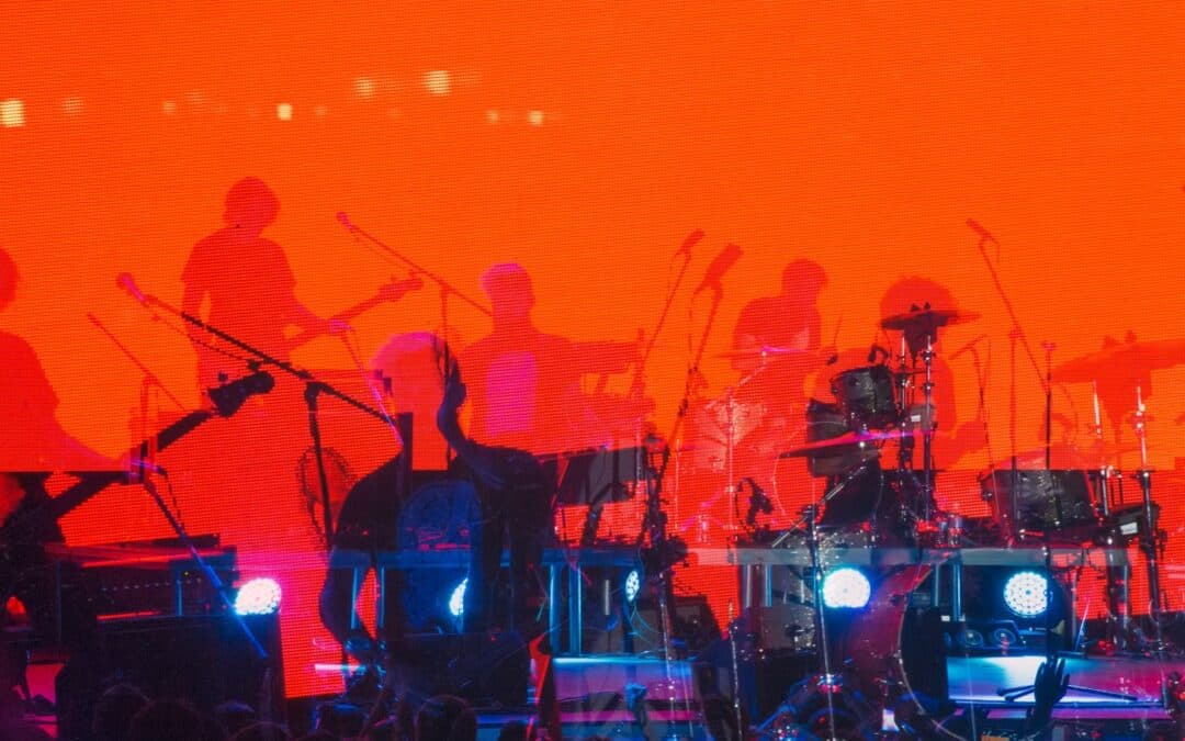 photo of a band silhouette performing on a stage