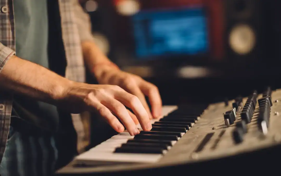 person playing piano keyboard