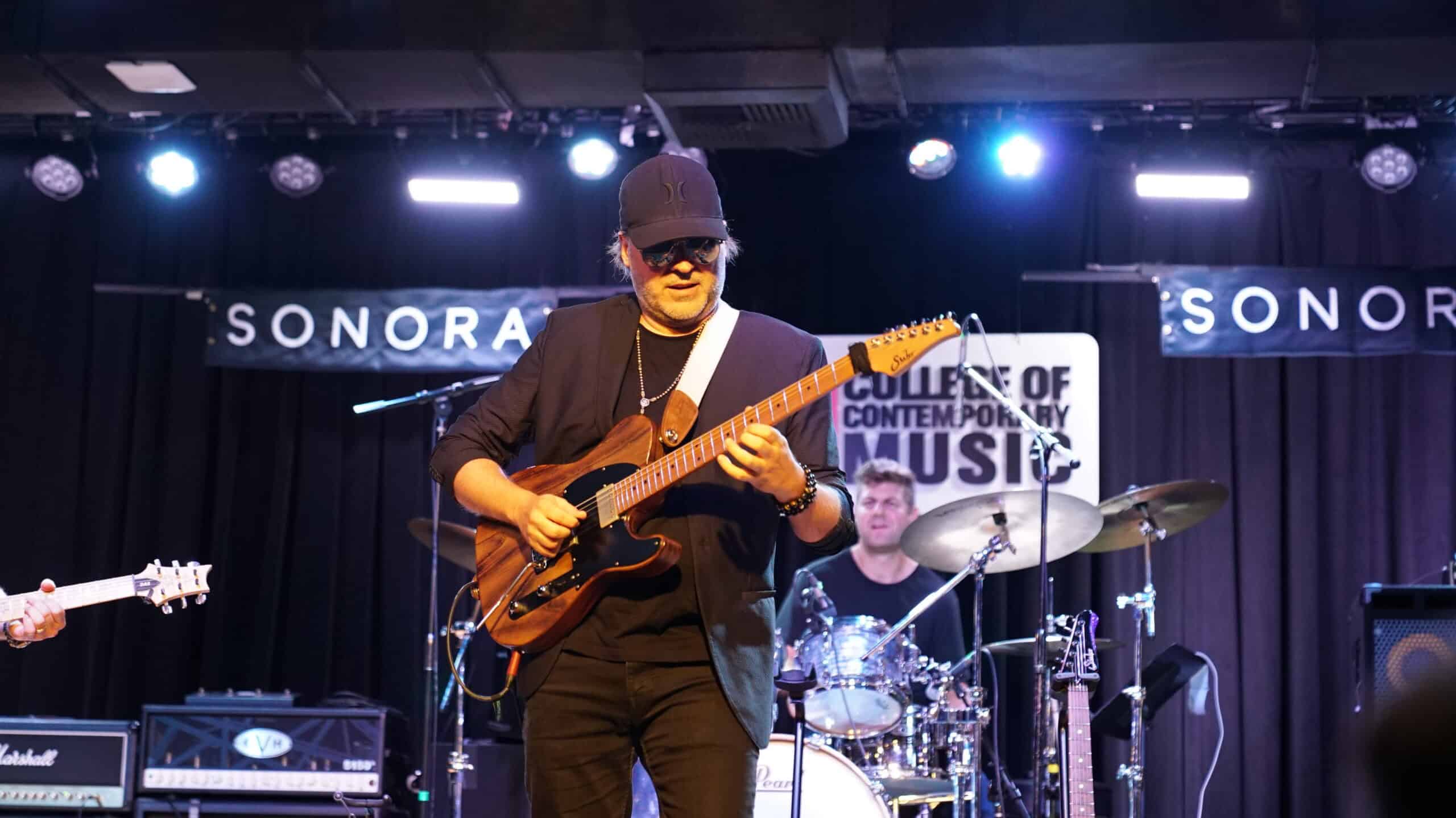 Andy Wood playing guitar live on stage at Musicians Institute in Hollywood