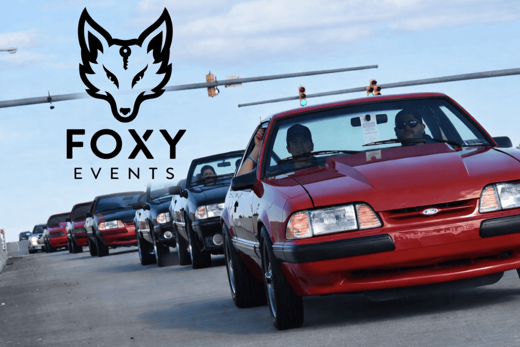 Line of red and black Ford Mustangs during Charlotte Mustang Week event.