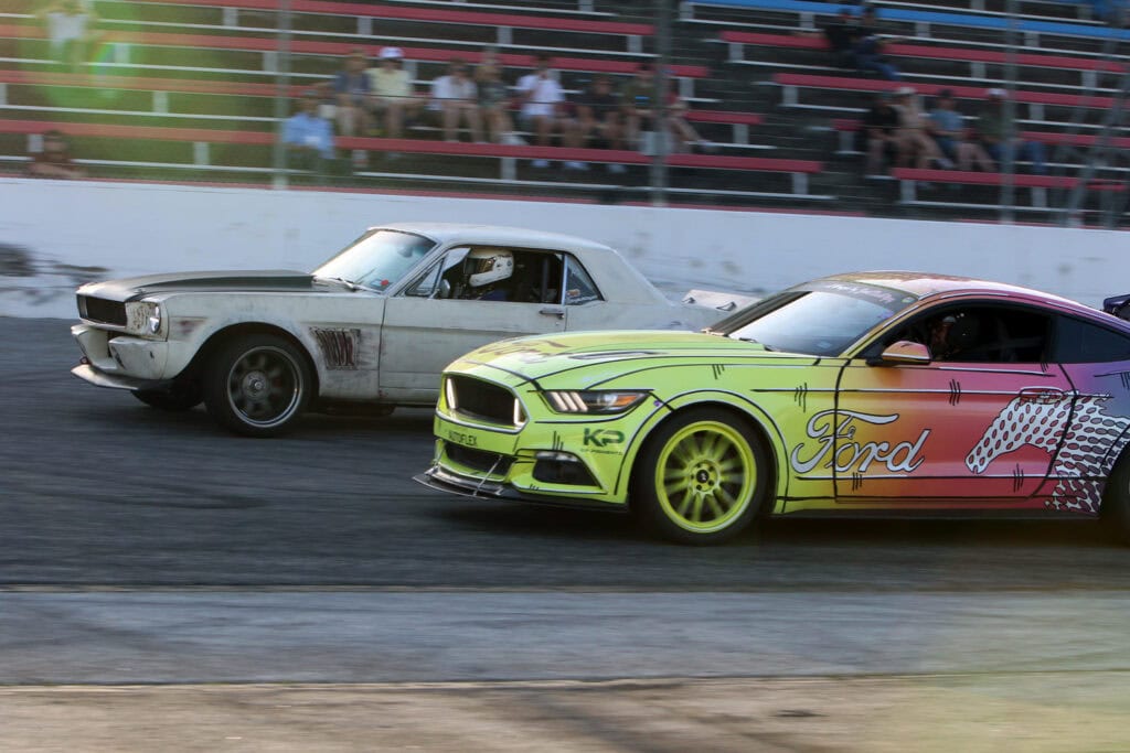High-speed Mustang race cars competing at Mustang Week Texas 2026 event.