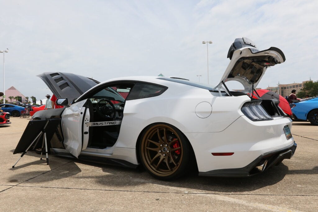 Mustang Week car with open hood and trunk, showcasing custom modifications and awards.