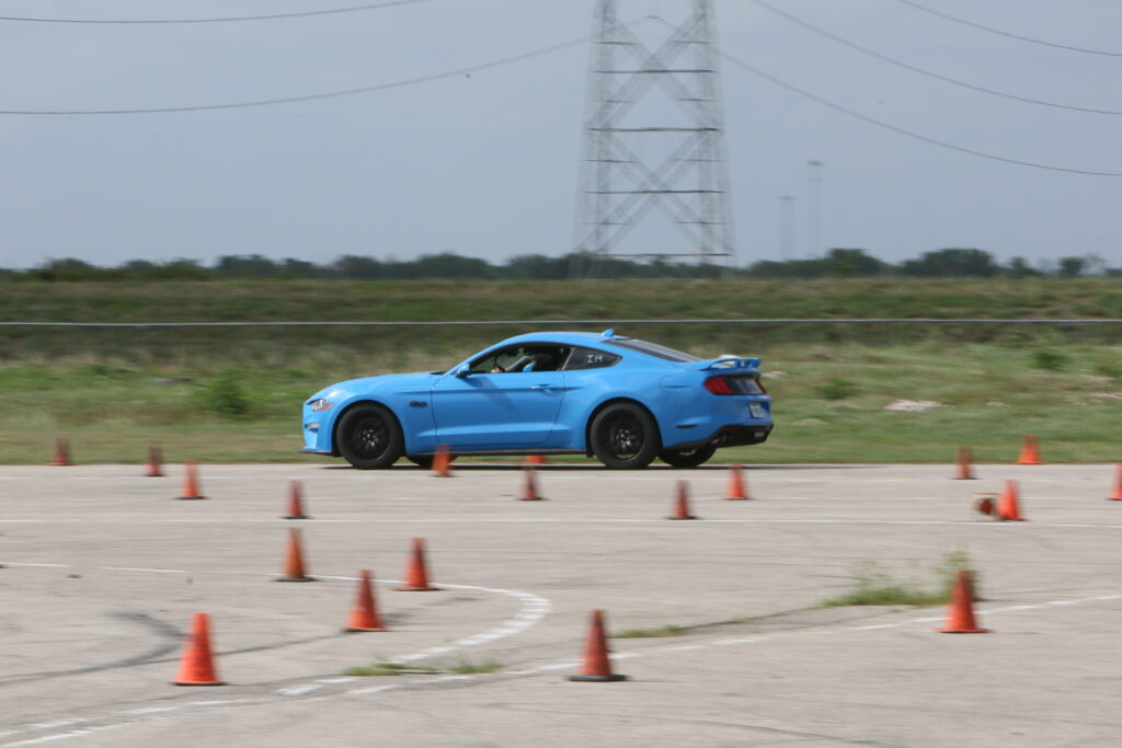 Blue Ford Mustang participating in autocross at Mustang Week 2026.