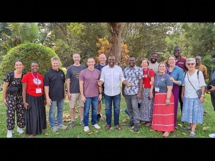 Diverse group of worship leaders and musicians at NLW International event outdoors.