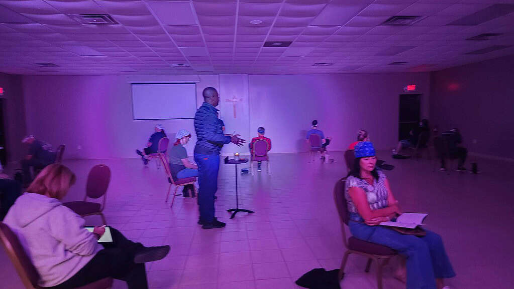 Worship session at NLW International with participants engaged in prayer and reflection.