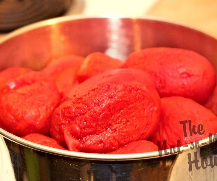 Delicious Restaurant Style Homemade Salsa Recipe with 4 Tips for Water Bath Canning | The Not so Modern Housewife pealed tomatoes in a stainless steel bowl to be prepared for homemade salsa recipe