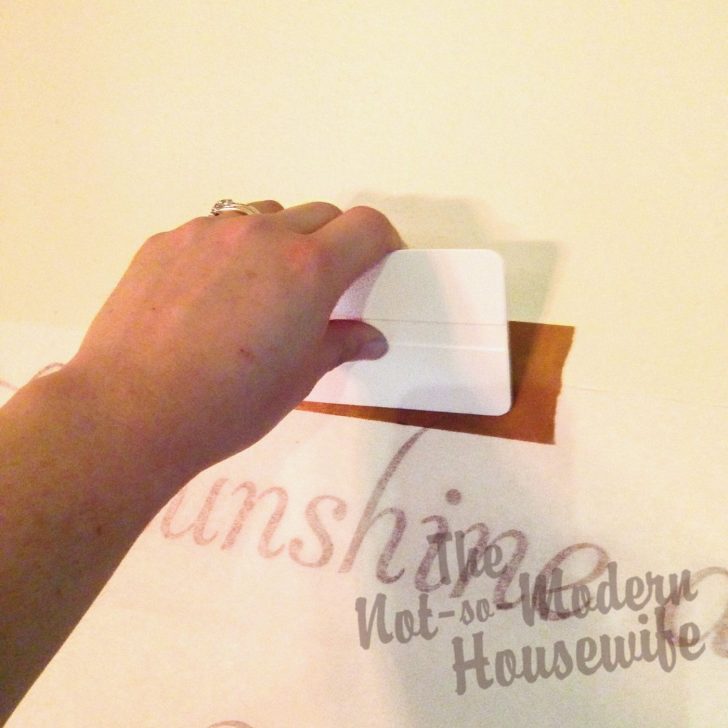 Transform Your Textured Walls with Custom Vinyl Lettering: A Step-by-Step Guide! | The Not so Modern Housewife Use squeegee to apply wall art to textured wall