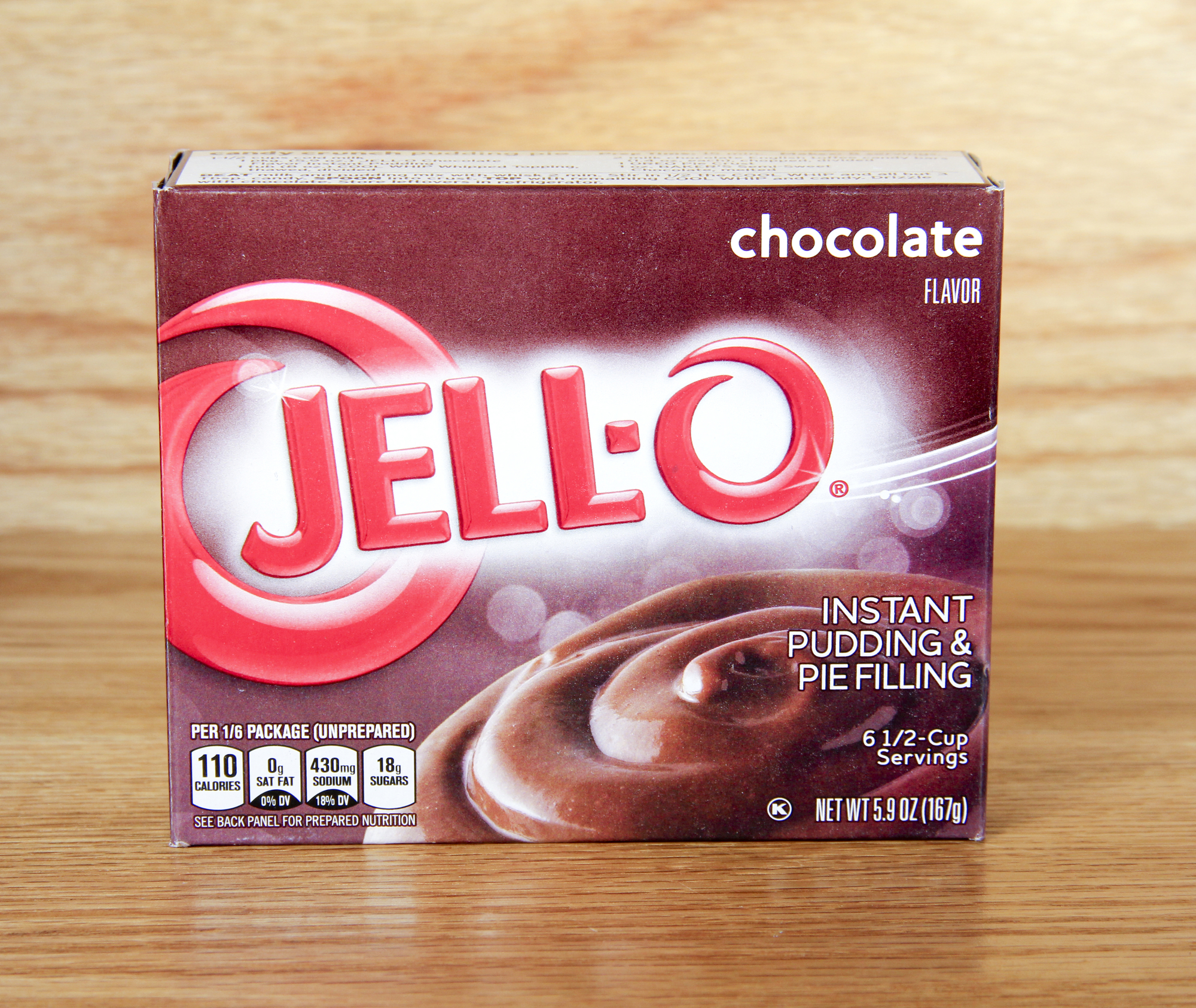 A box of Jell-O instant chocolate pudding mix, a key ingredient for enhancing the moisture and flavor of box cake mix with pudding. Adding instant pudding mix to cake batter creates a soft, bakery-quality texture, making it a popular baking hack for moist cakes. Perfect for quick and easy homemade desserts with rich chocolate flavor.