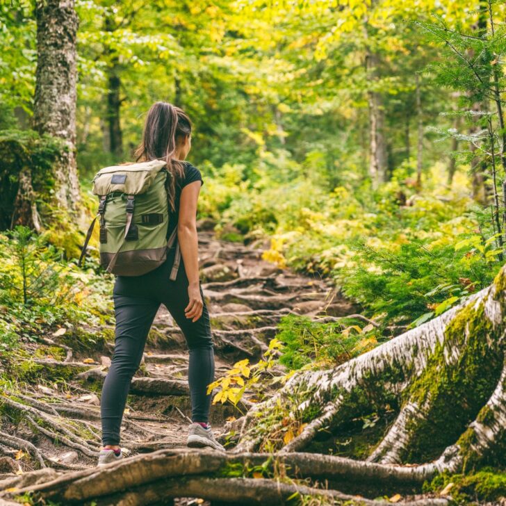 Understanding and Managing Estrogen Dominance Naturally | The Not so Modern Housewife woman hiking with backpack - exercise to balance hormones
