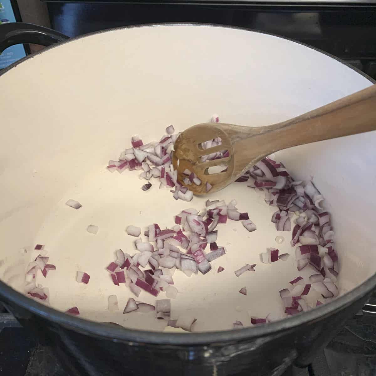 Sautéing the onions in a dutch oven.