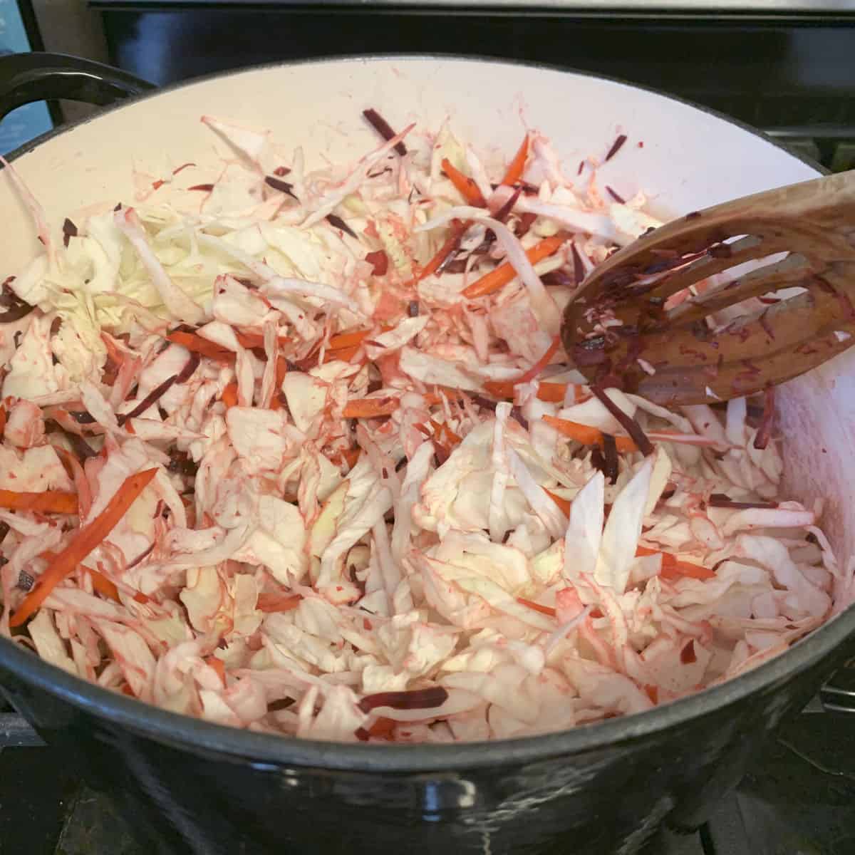Sautéing the cabbage in a dutch oven.
