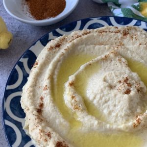 Creamy hummus dip on a plate.