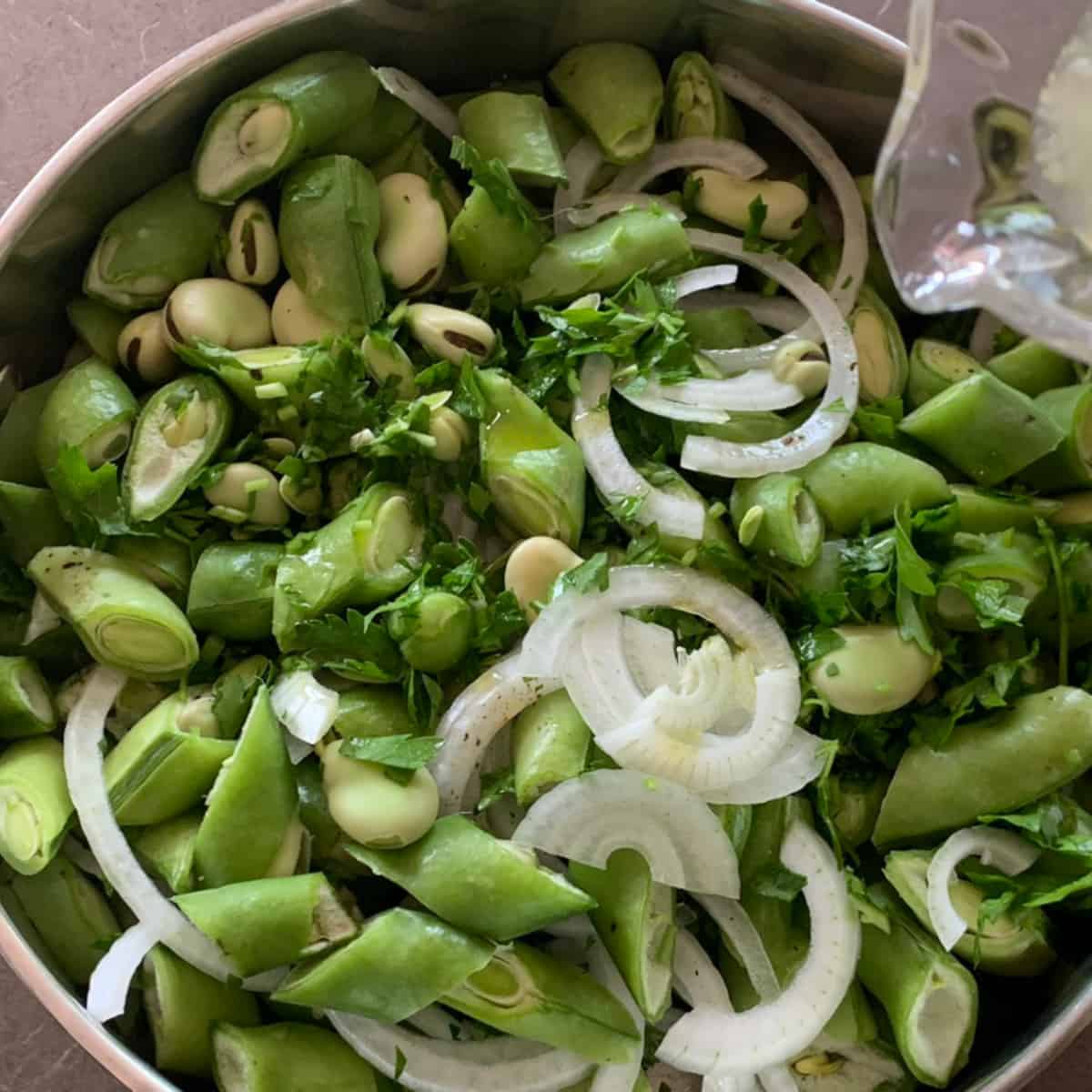 adding water to the fava beans.