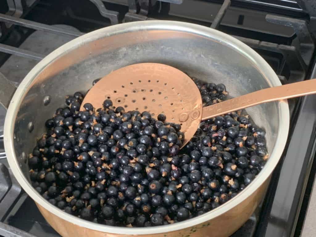 Cooking the blackcurrant berries.