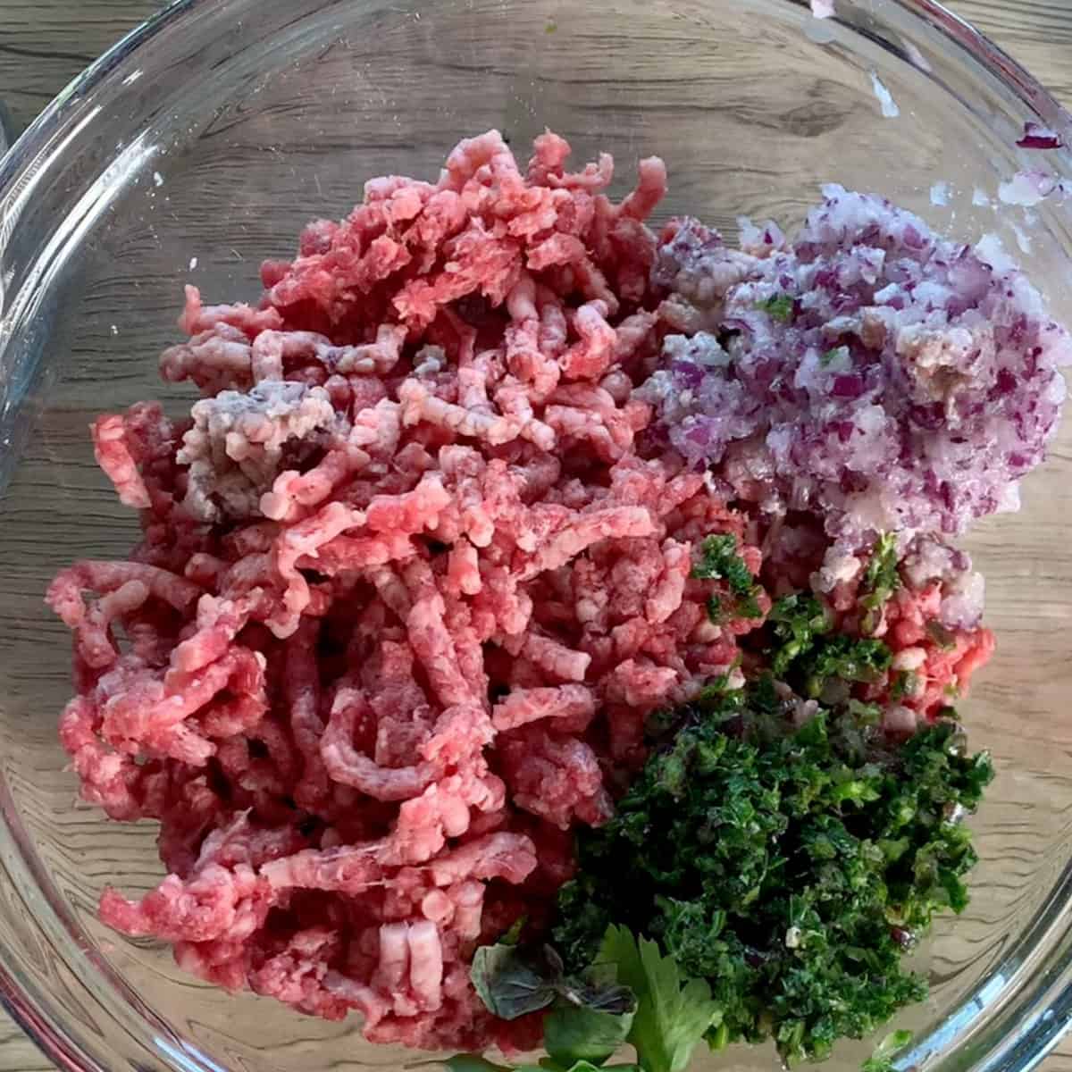 The beef with chopped onions and fresh herbs.
