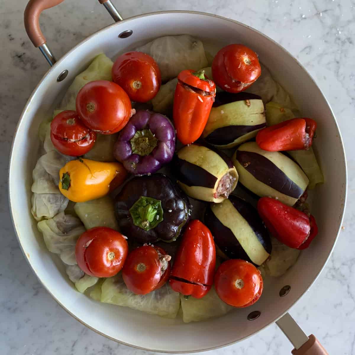 Stuffed vegetables form Armenian tolma are neatly nestles in the wide shallow pan.