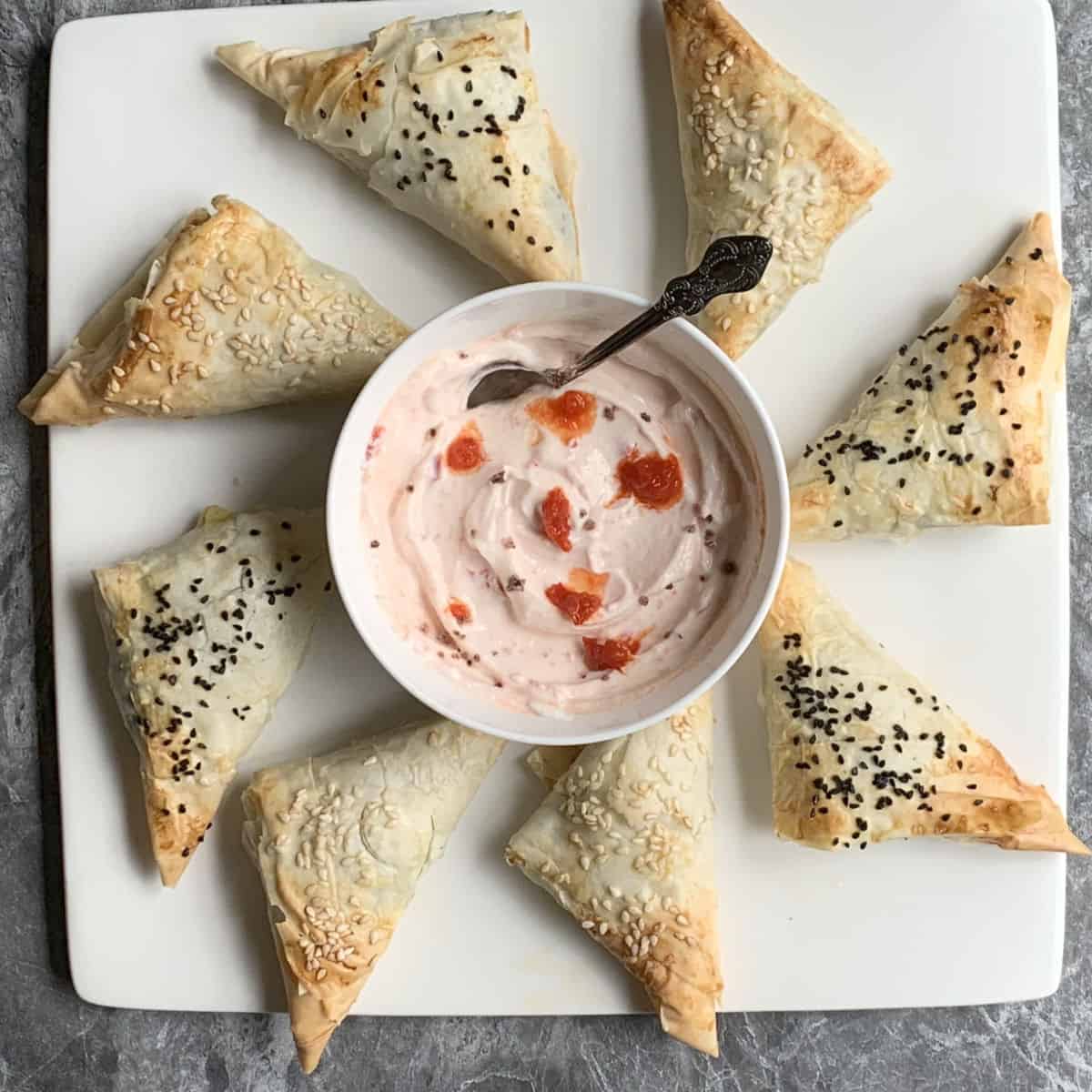 Spinach pies with kefir cheese and red pepper dip.