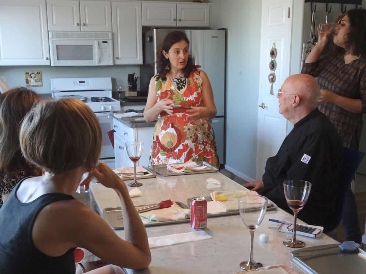 In the spanakopita class, students are listening to the instructions.
