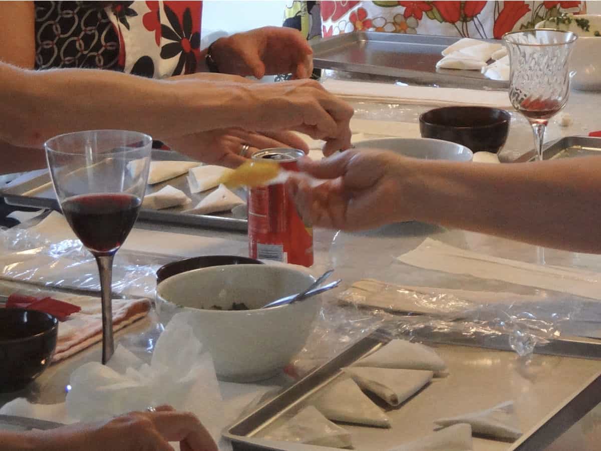 In the spanakopita class, students are folding the pies.
