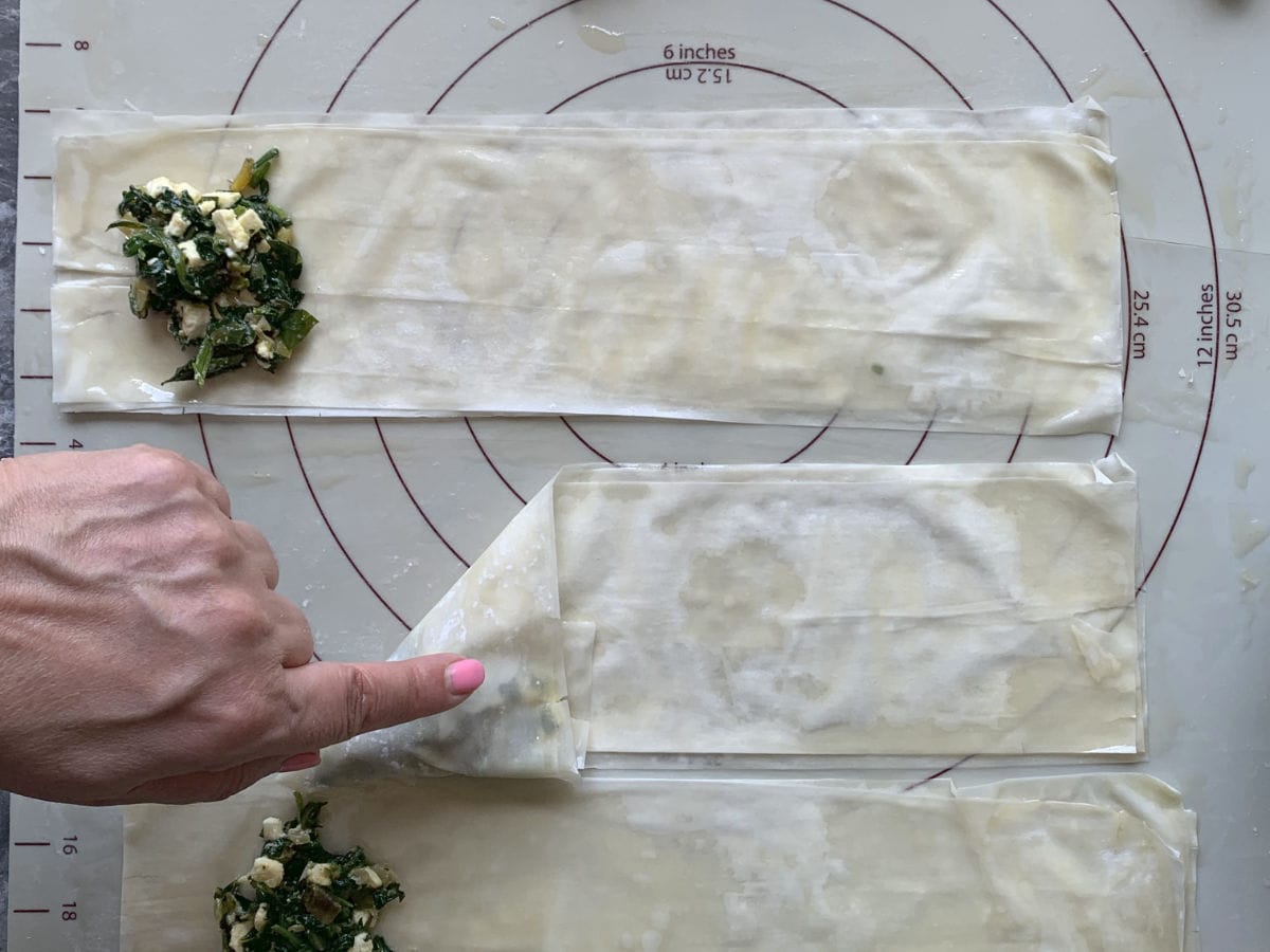 Folding phyllo dough in diagonal.