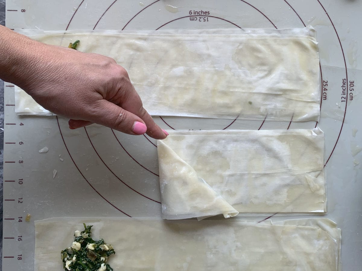 Folding phyllo dough in diagonal.