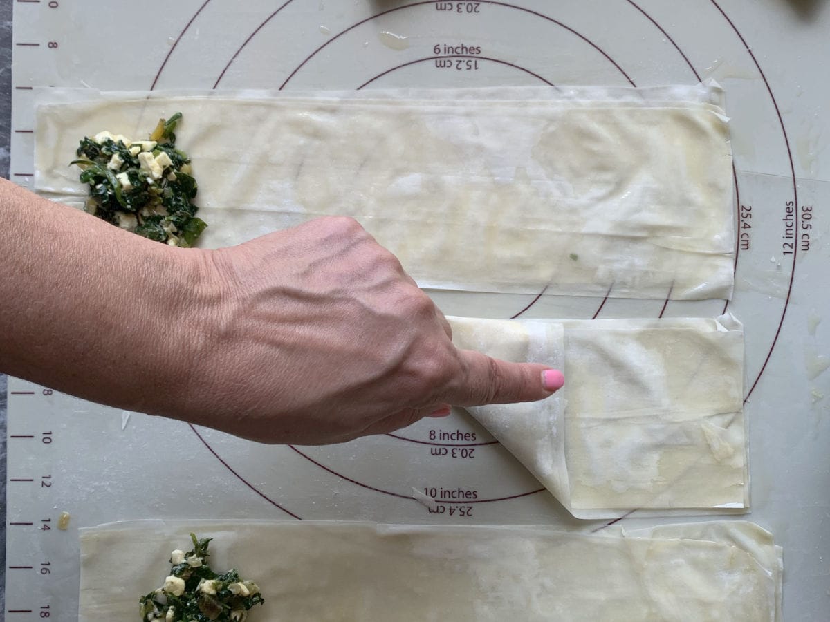 Folding phyllo dough in diagonal.