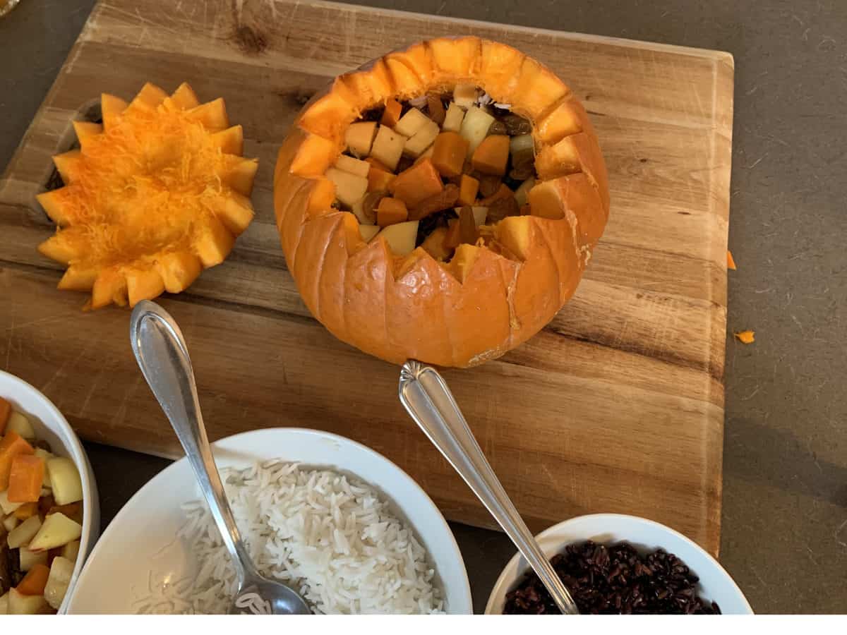 Pumpkin is being stuffed with fruits.