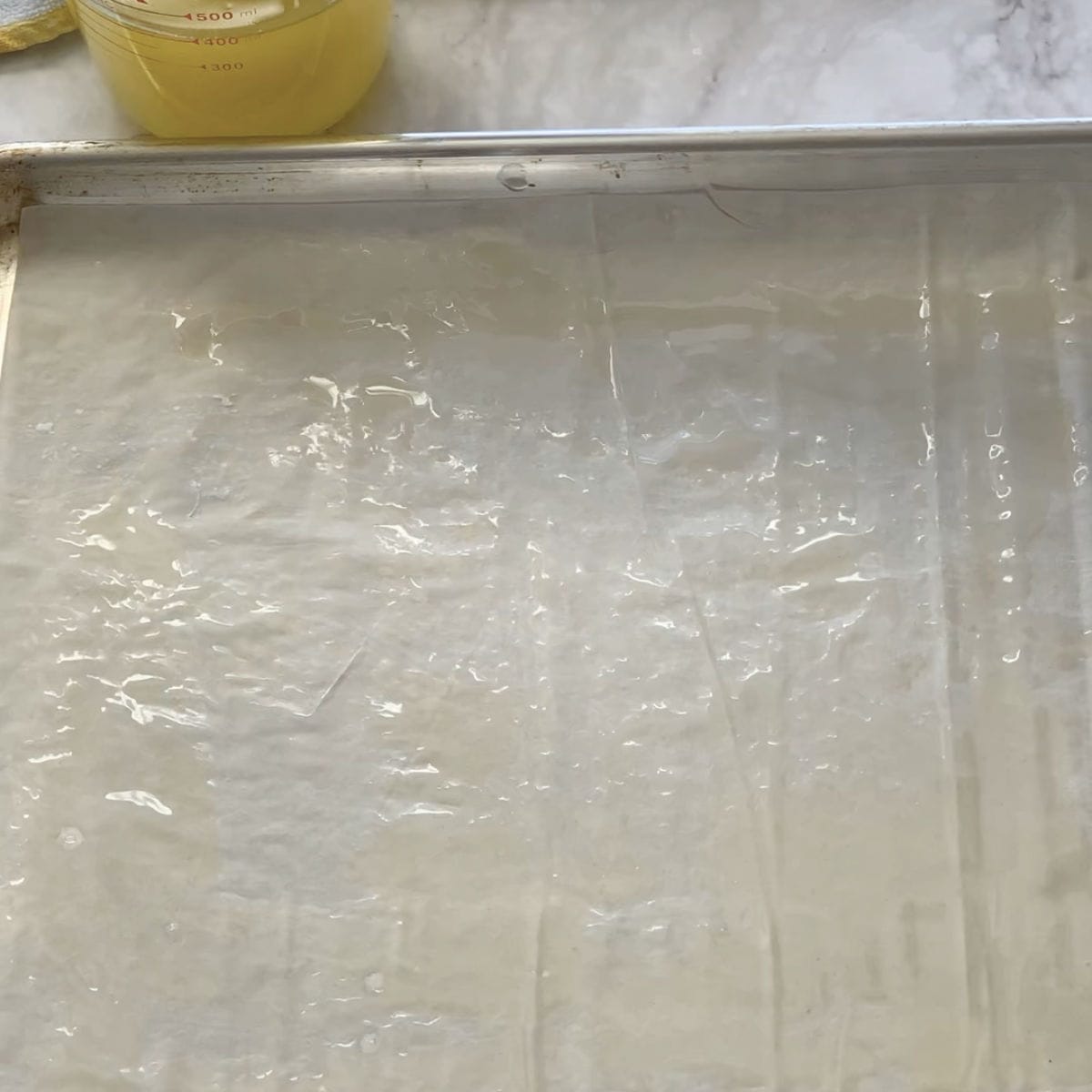 Layering phyllo sheets.