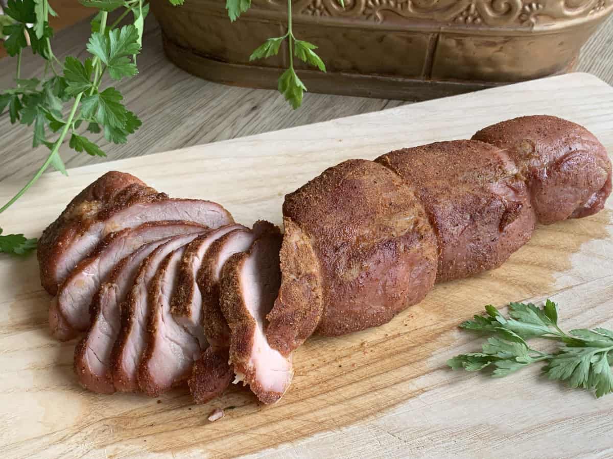 Smoked pork ready to eat on a cutting board.