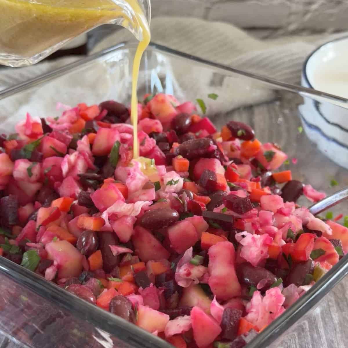 Vinegret beetroot potato salad drizzled with vinaigrette dressing.