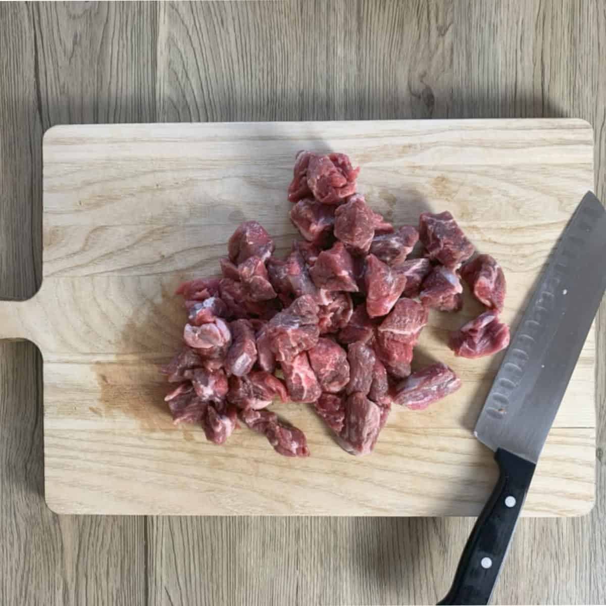 Three-bean-chili beef chunks on a cutting board. Three-bean-chili beef chunks on a cutting board.