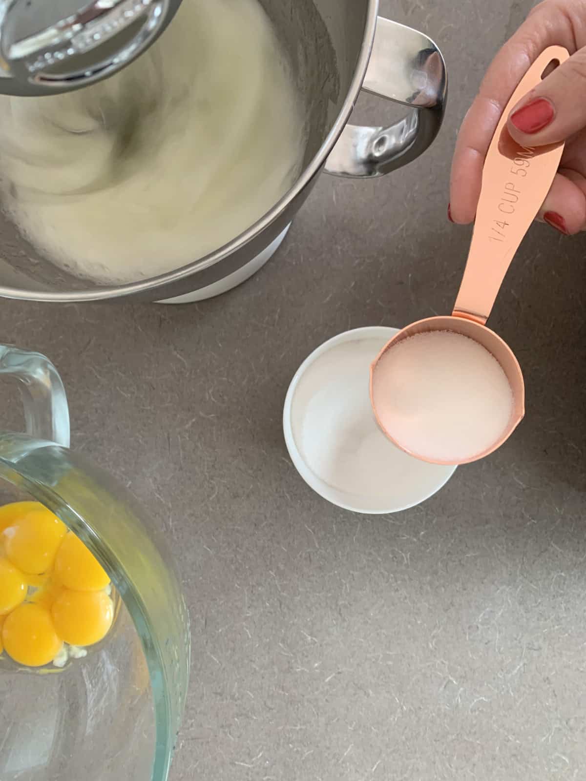 Adding sugar to egg whites.