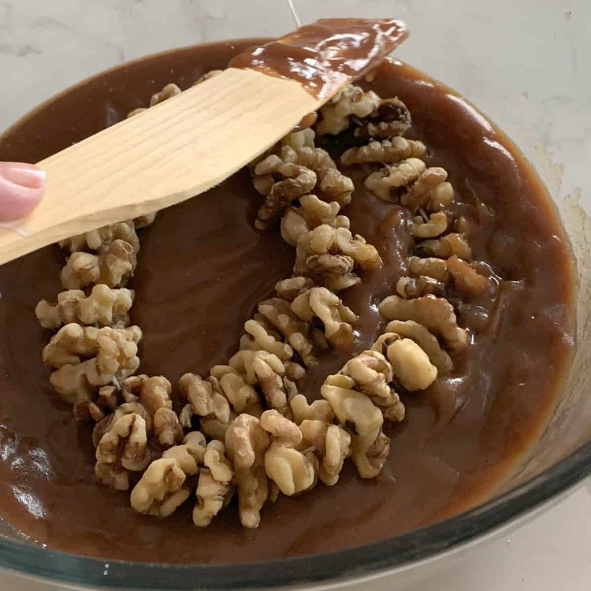 Dipping walnut string in shpot.