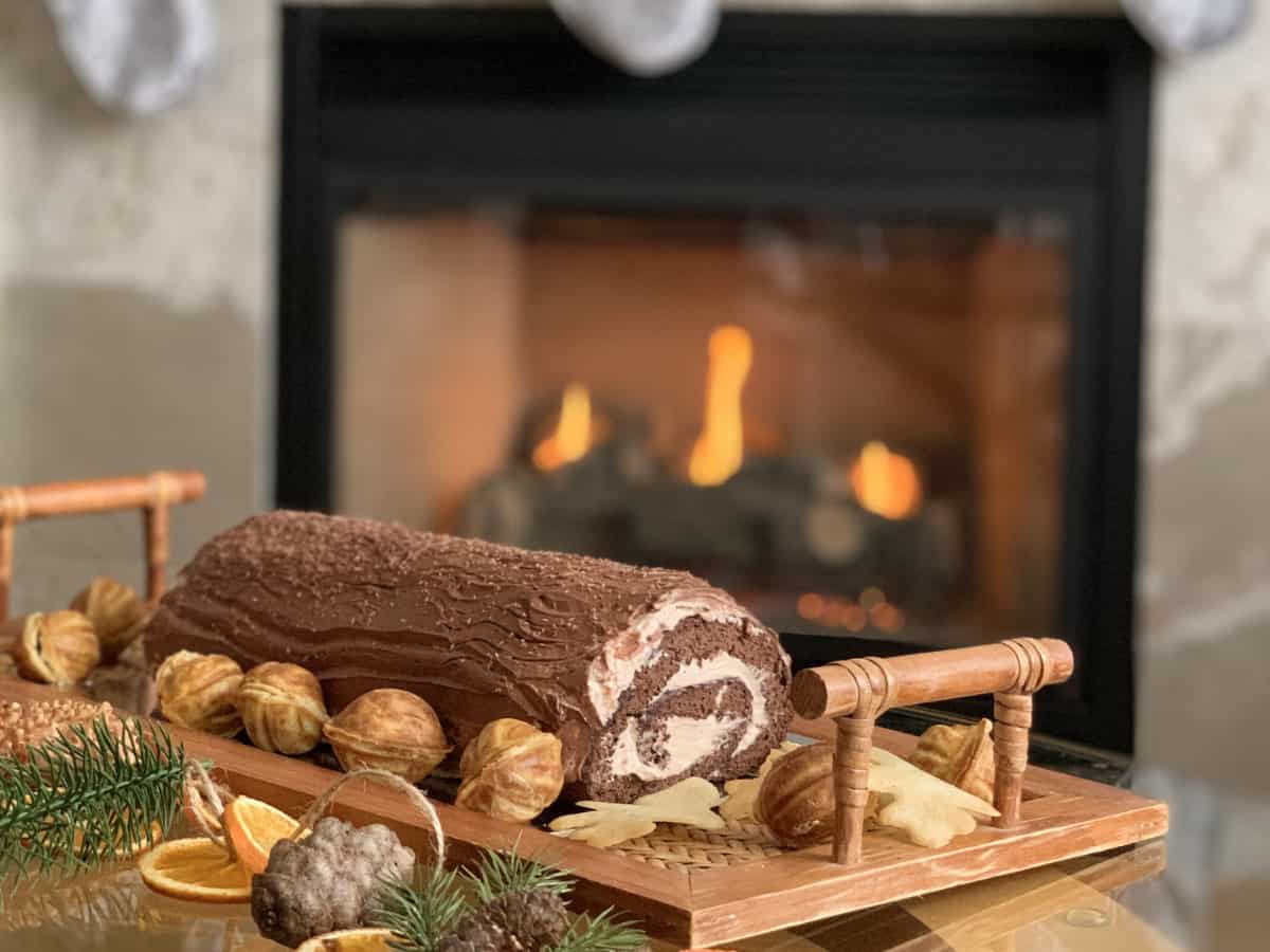 Buche De Noel Tiramisu-Cake in front of the fireplace.