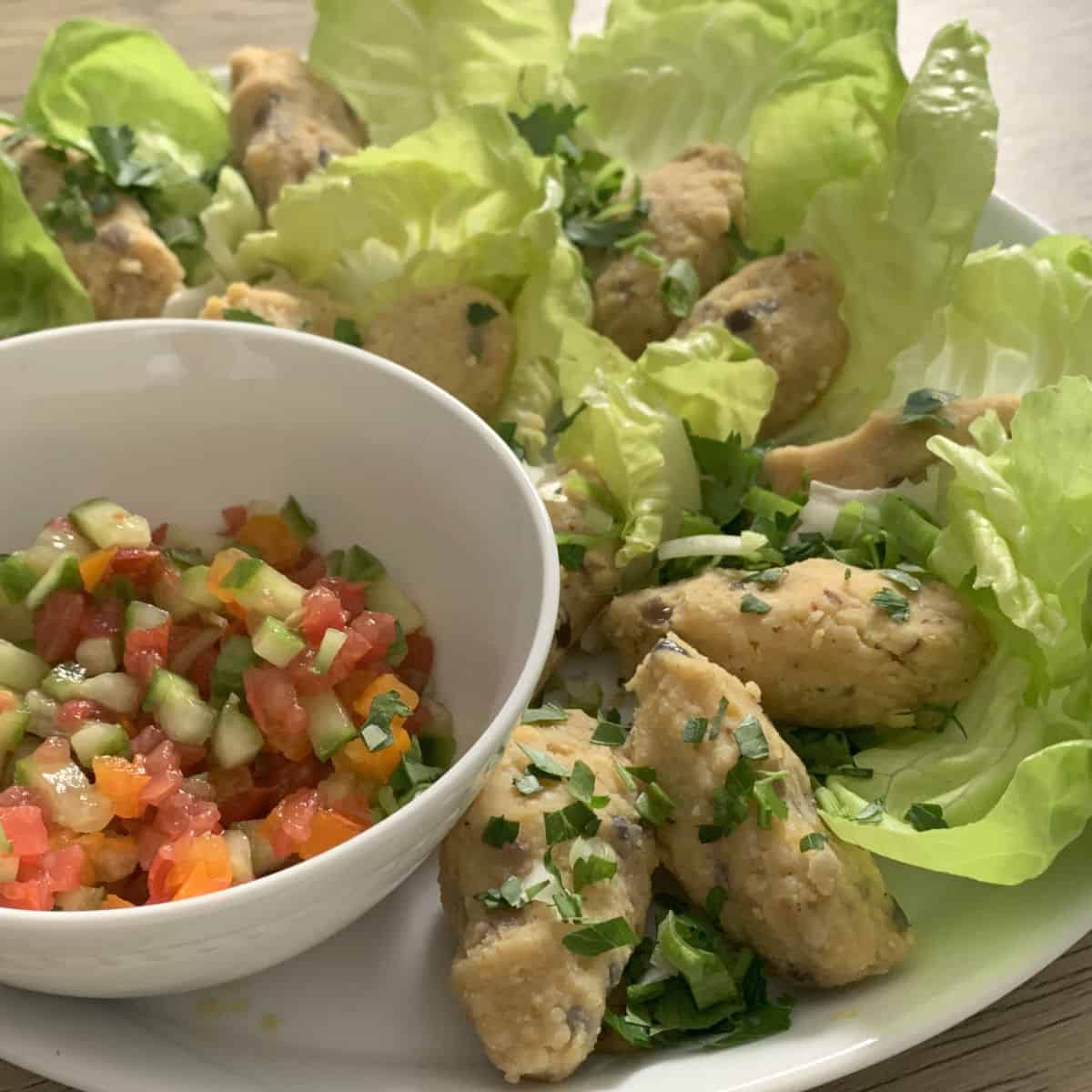 Red Lentil koftas on a bed of lettuce.
